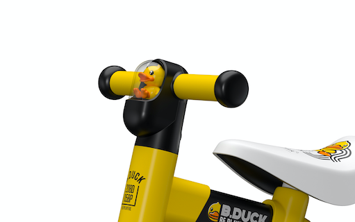 close up view of black and yellow kids tricycle handle