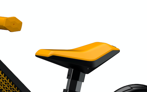 close up view of black and yellow balance bike seat