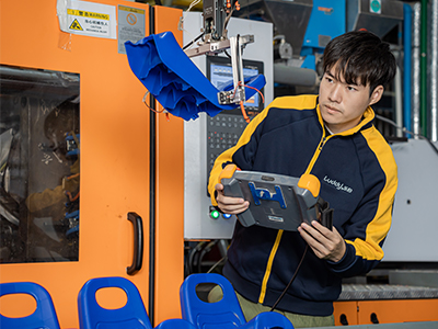 man measuring and weighing a seat attachment