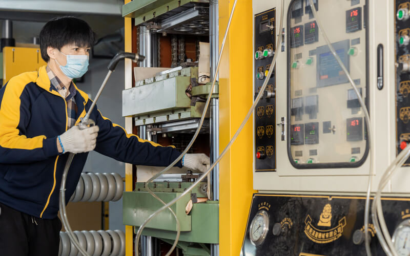 Luddy workers inspecting a production machine