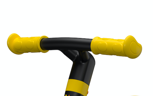 close up view of yellow and black balance bike handle