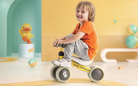 child playing with ride on cars