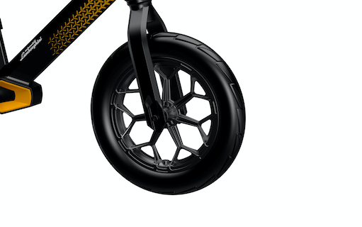 close up view of black and yellow balance bike front wheel